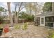 Backyard featuring stone patio with outdoor seating and a screened-in porch perfect for enjoying the outdoors at 928 Forest Blvd N Dr, Indianapolis, IN 46240