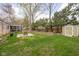 Spacious backyard featuring green lawn, a garden area, a storage shed, and a charming patio at 928 Forest Blvd N Dr, Indianapolis, IN 46240