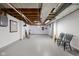 Unfinished basement with exposed ceiling, painted walls, and painted concrete floor, offering potential for customization at 928 Forest Blvd N Dr, Indianapolis, IN 46240