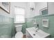 Clean bathroom with white fixtures and tiled walls and a large mirror at 928 Forest Blvd N Dr, Indianapolis, IN 46240