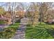 Inviting single-story home with a long driveway, mature trees, and a well-manicured lawn at 928 Forest Blvd N Dr, Indianapolis, IN 46240