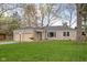 Charming stone home featuring an attached two-car garage and a well-maintained lawn at 928 Forest Blvd N Dr, Indianapolis, IN 46240