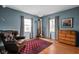 Comfortable living room with an armchair, wood floors, and natural light from two windows at 928 Forest Blvd N Dr, Indianapolis, IN 46240