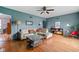Comfortable living room featuring hardwood floors, a ceiling fan, and ample natural light at 928 Forest Blvd N Dr, Indianapolis, IN 46240