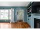 Inviting living room with a cozy fireplace, built-in bookshelves, and a large window at 928 Forest Blvd N Dr, Indianapolis, IN 46240