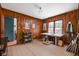 Wood paneled office space with a light colored desk, a chair and a bright window at 928 Forest Blvd N Dr, Indianapolis, IN 46240