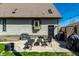 This backyard patio features modern seating, a grill, and a grassy lawn with a well-maintained exterior at 933 Tecumseh St, Indianapolis, IN 46201