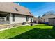 The backyard has a patio set, grill, and a lush lawn, offering a pleasant outdoor space at 933 Tecumseh St, Indianapolis, IN 46201