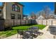 Backyard with a cozy patio set surrounded by lush greenery and privacy fencing, perfect for outdoor relaxation at 933 Tecumseh St, Indianapolis, IN 46201