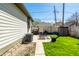 View of the backyard featuring a patio set, grill, storage shed, and a grassy lawn at 933 Tecumseh St, Indianapolis, IN 46201