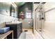 Bathroom featuring a shower with glass door and classic sink at 933 Tecumseh St, Indianapolis, IN 46201