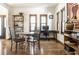 Open dining area with hardwood floors, natural light, and desk at 933 Tecumseh St, Indianapolis, IN 46201