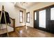 Bright foyer featuring hardwood floors, staircase, and natural light at 933 Tecumseh St, Indianapolis, IN 46201