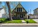 Charming two-story home featuring a steeply pitched roof and inviting front porch at 933 Tecumseh St, Indianapolis, IN 46201