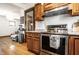 Updated kitchen features stainless steel appliances and adjacent living space at 933 Tecumseh St, Indianapolis, IN 46201