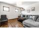 Cozy living room featuring wood floors, a comfortable sectional sofa, and natural light at 933 Tecumseh St, Indianapolis, IN 46201
