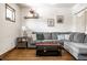 Charming living room with a cozy sectional sofa, decor, and warm wood floors at 933 Tecumseh St, Indianapolis, IN 46201