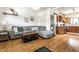Bright living room features a comfortable gray sofa, light hardwood floors, and decor at 933 Tecumseh St, Indianapolis, IN 46201