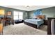 Spacious bedroom with a queen size bed, desk, and natural light from the window at 950 Redwood Dr, Franklin, IN 46131