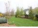 Serene backyard with lush green lawn, flowering trees, and well-manicured landscaping creates a private oasis at 10235 Normandy Way, Fishers, IN 46040