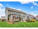 Spacious backyard with lush green grass, beautiful landscaping, a patio, and an inviting outdoor seating area at 10235 Normandy Way, Fishers, IN 46040