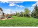Well-maintained backyard with a large lawn area, mature trees, landscape beds, and serene atmosphere at 10235 Normandy Way, Fishers, IN 46040