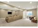 Finished basement featuring recessed lighting, wall-mounted TV, a large sectional sofa, and a comfortable sitting area at 10235 Normandy Way, Fishers, IN 46040