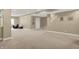 A spacious basement with neutral paint, plush carpet, recessed lighting, and a seating area perfect for relaxation at 10235 Normandy Way, Fishers, IN 46040