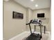 Finished basement workout area features a treadmill and modern lighting at 10235 Normandy Way, Fishers, IN 46040