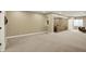 Large open basement with plush carpet, and a comfortable sofa in the corner at 10235 Normandy Way, Fishers, IN 46040
