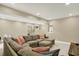 Finished basement features plush carpet, neutral paint, and a comfortable sectional sofa at 10235 Normandy Way, Fishers, IN 46040