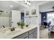 Bathroom featuring a double vanity with white countertop, framed mirrors, and an open doorway to the bedroom at 10235 Normandy Way, Fishers, IN 46040