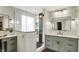 Modern bathroom featuring double vanities, stylish mirrors, and a glass-enclosed walk-in shower at 10235 Normandy Way, Fishers, IN 46040