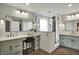 Modern bathroom featuring double vanities, stylish mirrors, and a glass-enclosed walk-in shower at 10235 Normandy Way, Fishers, IN 46040