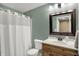 Bathroom with a wooden vanity, framed mirror, and a shower with a curtain at 10235 Normandy Way, Fishers, IN 46040