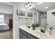 Bathroom featuring a double vanity with a white countertop, framed mirrors, and view into an adjacent bedroom at 10235 Normandy Way, Fishers, IN 46040