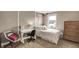 Cozy bedroom featuring neutral walls, a double bed, a window with a view, a desk, and a chair at 10235 Normandy Way, Fishers, IN 46040