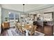 Bright dining room adjacent to the kitchen, featuring hardwood floors and a large window at 10235 Normandy Way, Fishers, IN 46040