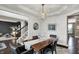 Elegant dining room features a modern chandelier and views of a cozy living space with a staircase at 10235 Normandy Way, Fishers, IN 46040