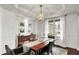 Bright dining room with a decorative chandelier and a view through the window at 10235 Normandy Way, Fishers, IN 46040