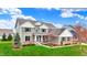 Charming two-story home featuring manicured lawn, brick accents, and a covered front porch at 10235 Normandy Way, Fishers, IN 46040