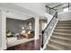 Open foyer with staircase and dark wood floors, flowing into a living area with neutral colors and natural light at 10235 Normandy Way, Fishers, IN 46040