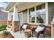 Cozy front porch with comfortable seating, potted flowers, and view of the welcoming teal front door at 10235 Normandy Way, Fishers, IN 46040