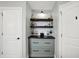 Hallway with built-in shelving, drawers, and cabinet space for storage and decorative display at 10235 Normandy Way, Fishers, IN 46040