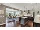 Open concept kitchen with a center island, modern lighting, and hardwood floors adjacent to dining area at 10235 Normandy Way, Fishers, IN 46040