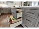 Well-organized kitchen island with gray cabinets, showcasing deep drawers with ample storage space and wooden interiors at 10235 Normandy Way, Fishers, IN 46040