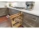 Kitchen showcasing custom cabinetry, spice rack pullout, and stainless-steel appliances at 10235 Normandy Way, Fishers, IN 46040