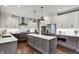 Kitchen featuring stainless steel appliances, a center island and modern lighting at 10235 Normandy Way, Fishers, IN 46040