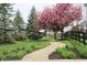 Beautiful landscaping with flowering trees, brick pathway, and lush greenery at 10235 Normandy Way, Fishers, IN 46040