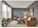 Cozy living room featuring a comfortable brown sofa and well-lit by a large window at 10235 Normandy Way, Fishers, IN 46040